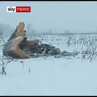 Crash debris strewn over snowy area