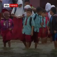 Children learn in flooded school
