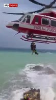 Tourists stranded on rocks winched to safety