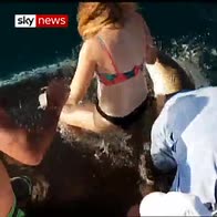 Shark pulls woman overboard by biting finger