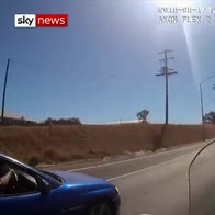 Swerving driver almost hits policeman on bike