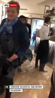 Diners eat pizza as restaurant floods