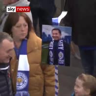 Leicester City players walk with fans