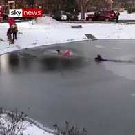 Moment boy rescued from frozen pond