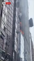 People climb down burning tower block