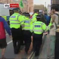 Man  shoved by police arresting protesters
