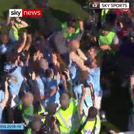 Manchester City players lift Pep Guardiola