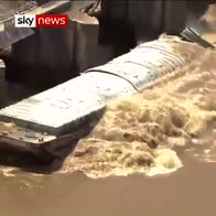Barges sinks after colliding with dam