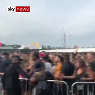 Crowd stampedes through barriers at festival