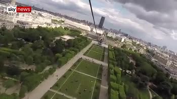 Thrill-seekers ride zip line from Eiffel Tower