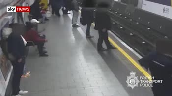 Moment man attempts to push man on to tracks