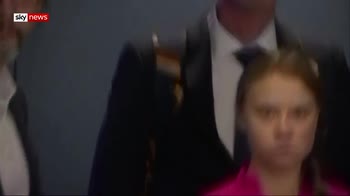 Greta looks on as Trump arrives at UN