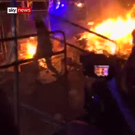 Riot police charge through fire in Barcelona