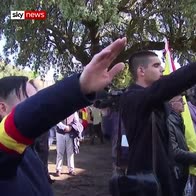 Franco supporters give fascist salutes