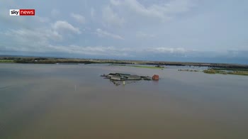 Drone shows farm cut off  by flood water
